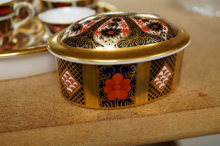 A small collection of Royal Crown Derby miniature tea for two and a pill box, tray 19cm wide. Saucer missing on tea for two.